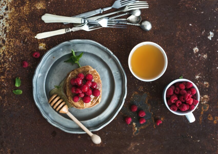 Breakfast set. Buckwheat pancakes with fresh raspberries