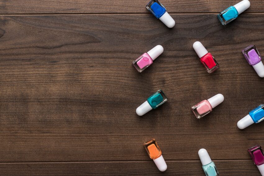 Nail Polish Bottles On Brown Wooden Table